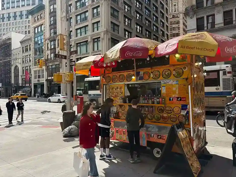 New York City Weather in June: Famous hot dog vendor on the corner of Broadway and 26th.